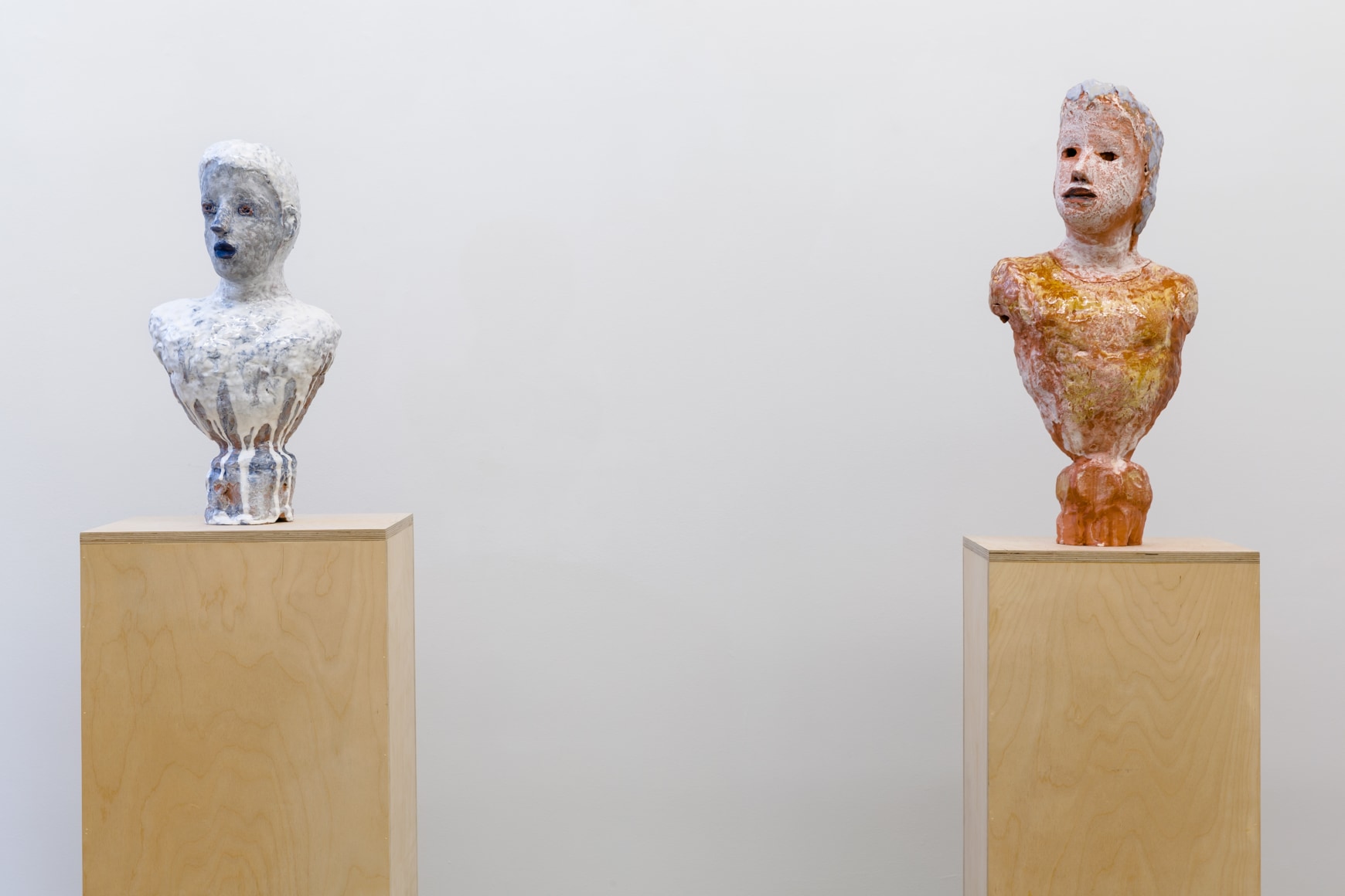 Two busts on separate pedestals