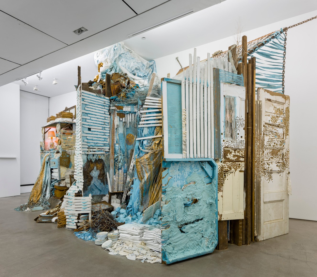 Large installation by Julie Schenkelberg including reclaimed wood and household materials