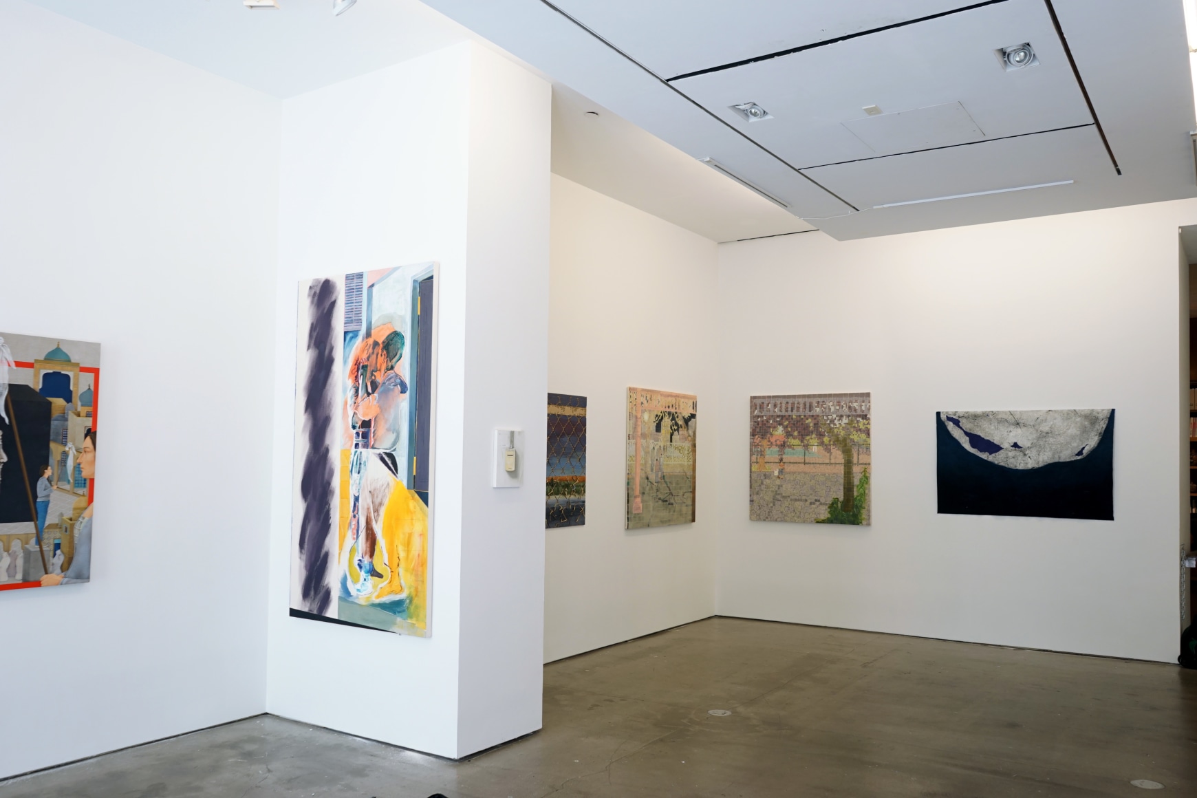 This is an installation view of the group exhibition Counter Narratives: Geographies of the Unfamiliar, which features paintings on the walls.