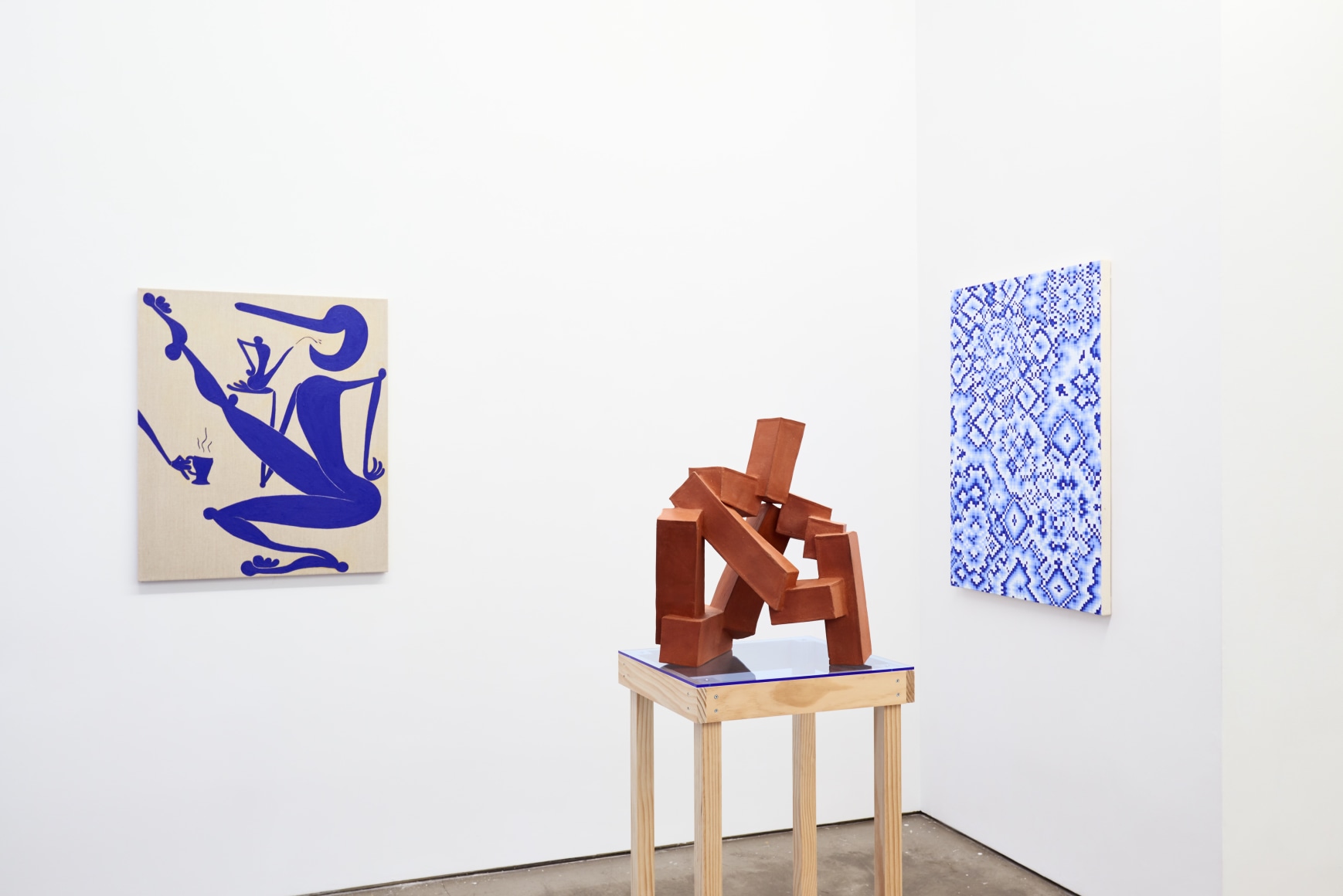 Installation view of works by Todd Kelly. Paintings and sculptures are next to each other.