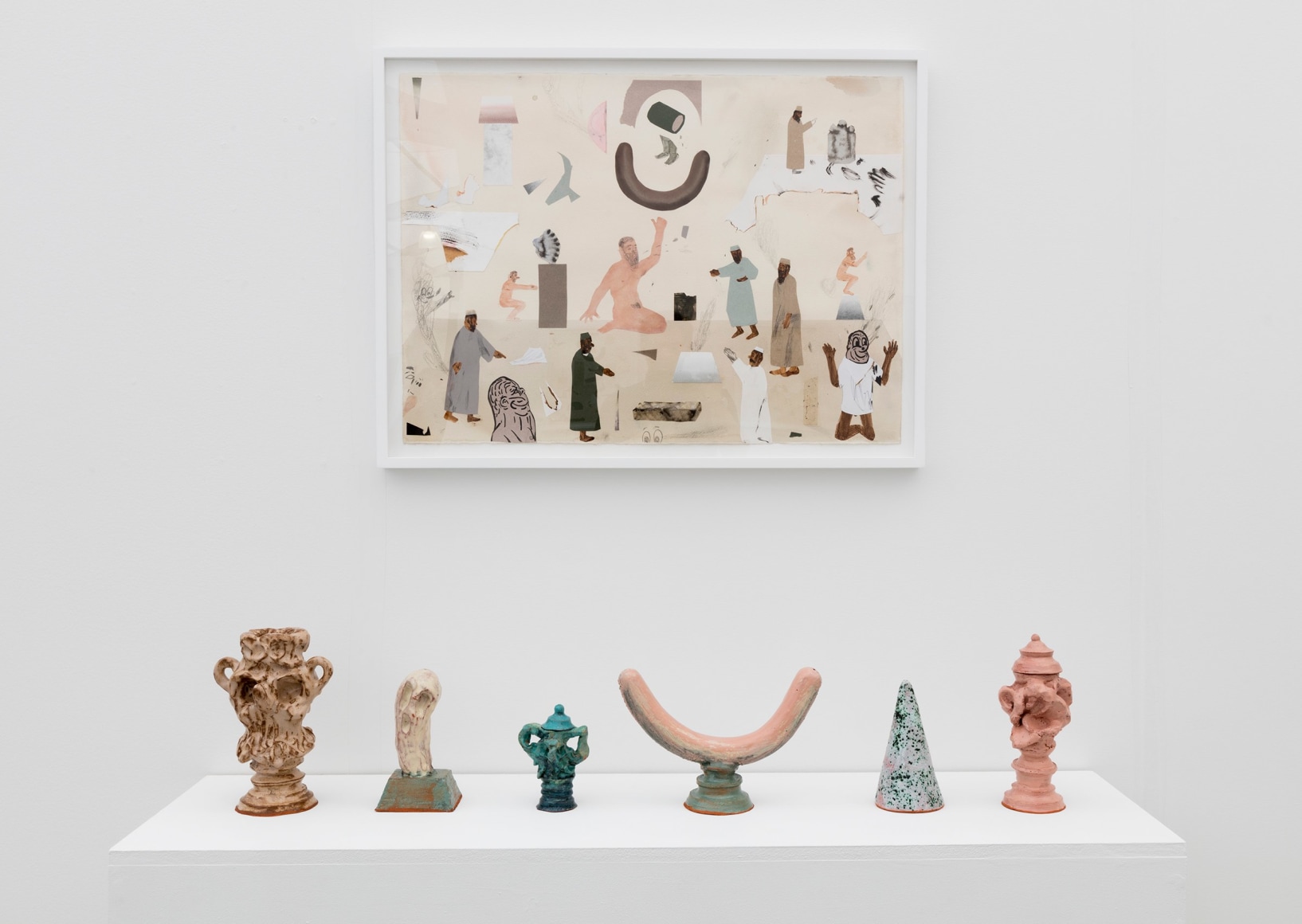 Installation image of the art fair booth at UNTITLED Miami. Framed works are on the walls and ceramic sculptures are on a shelf