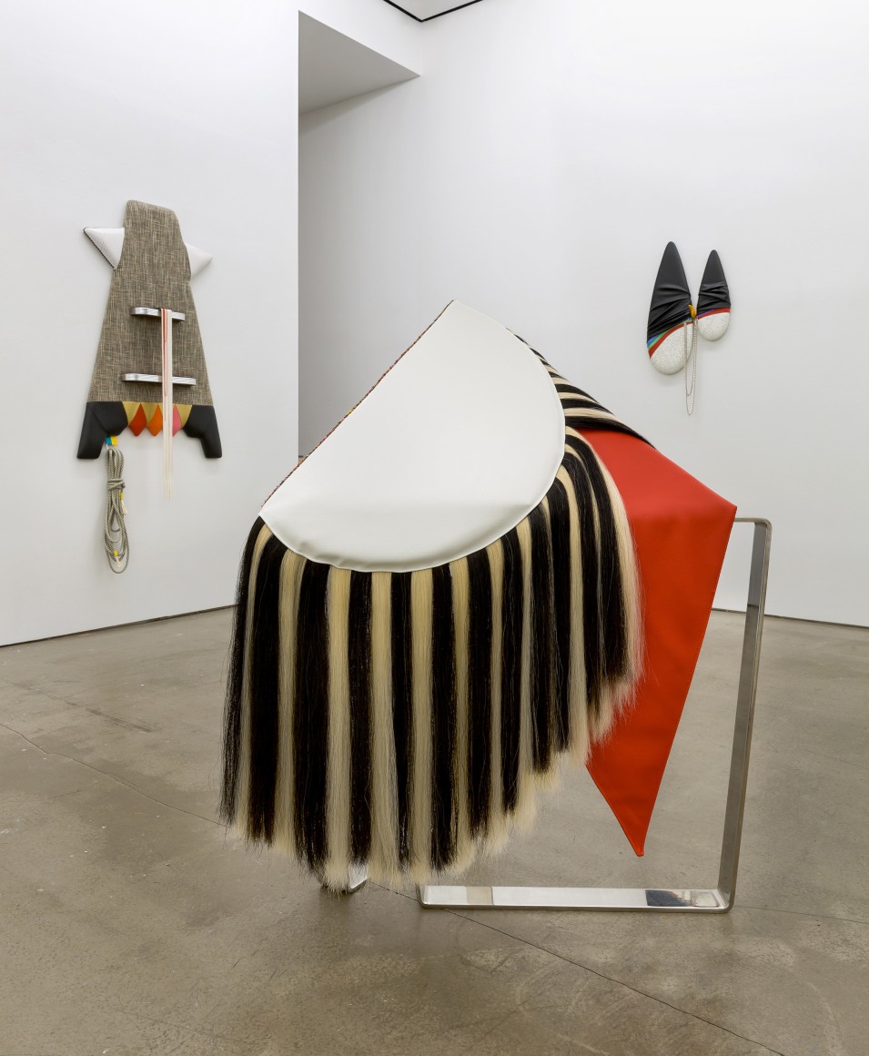 Installation view of Trish Tillman's exhibition "Stage Diver", which shows plush sculptures on the walls and standing on the floor.