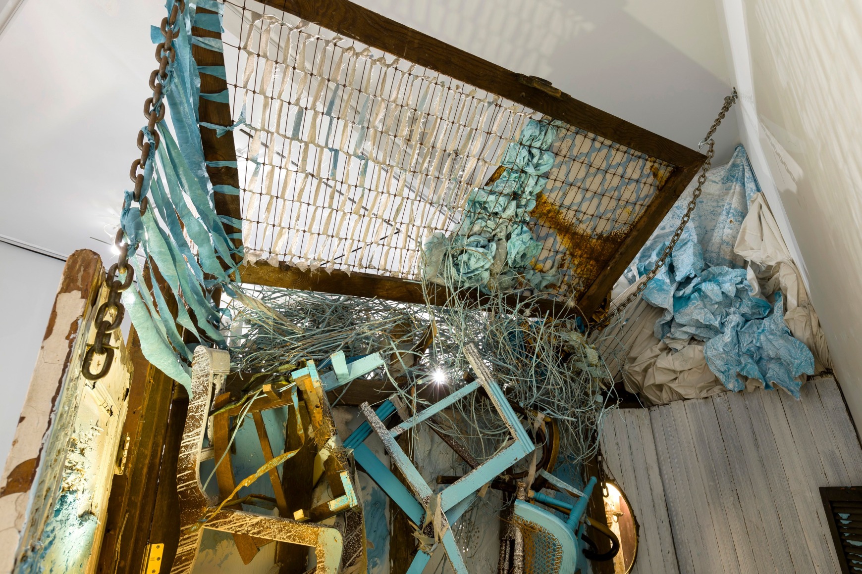 Large installation by Julie Schenkelberg including reclaimed wood and household materials