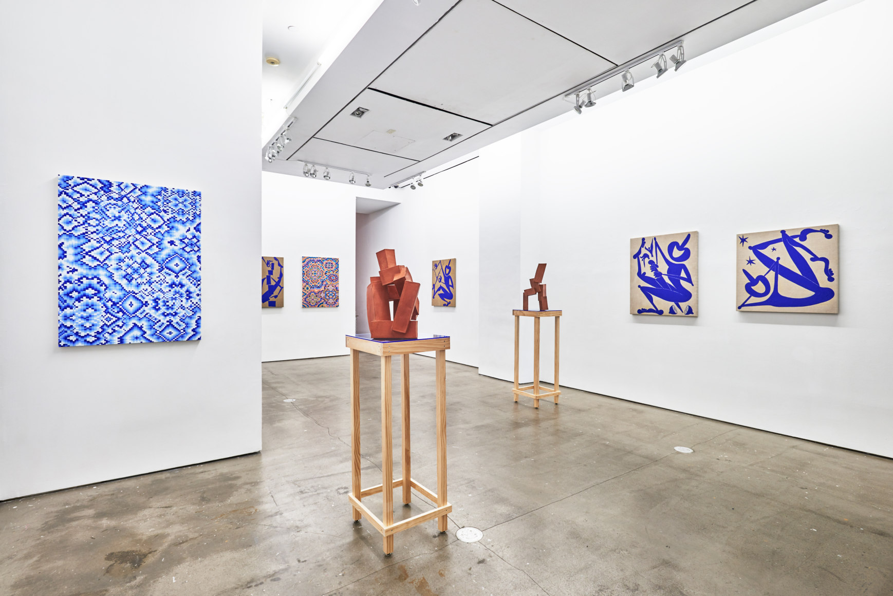 Installation view of works by Todd Kelly. Paintings and sculptures are next to each other.