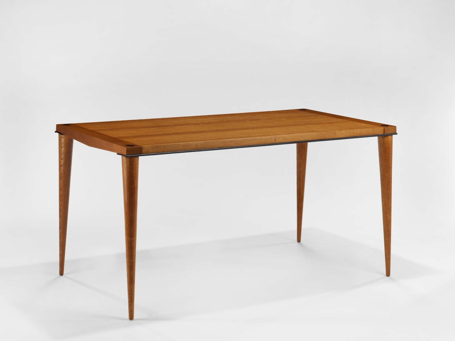 photograph of wood dining table in a blank room