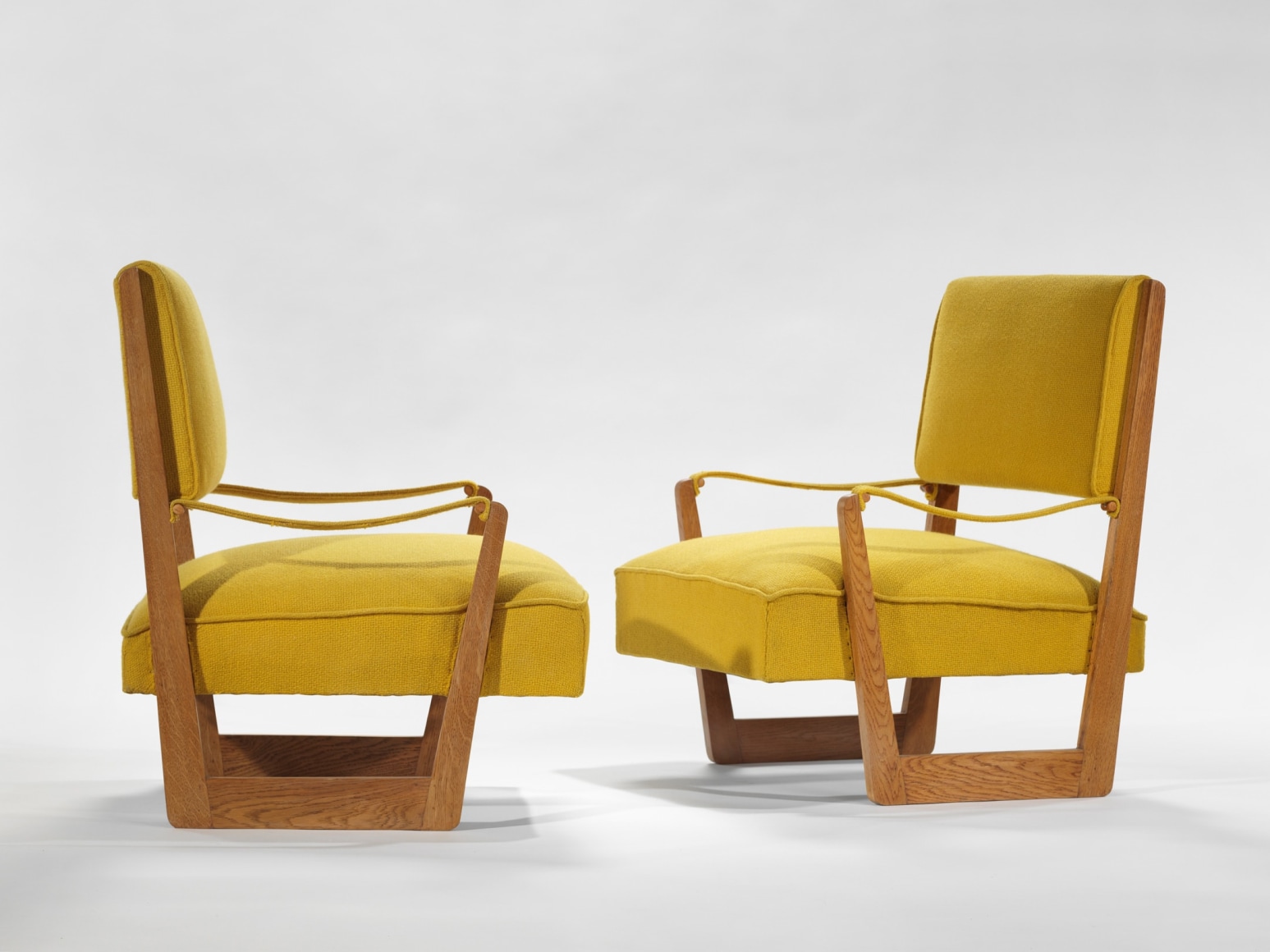 yellow and wood armchairs in an empty room