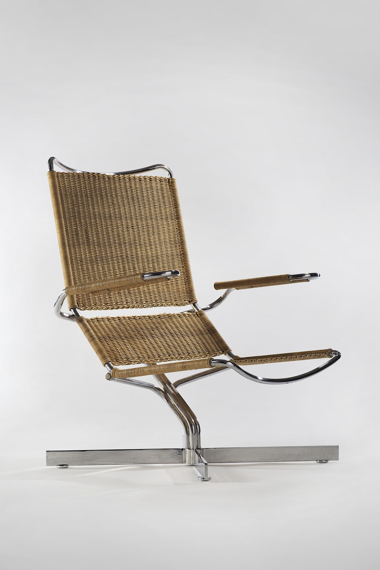 picture of rattan chair with steel legs in a blank room