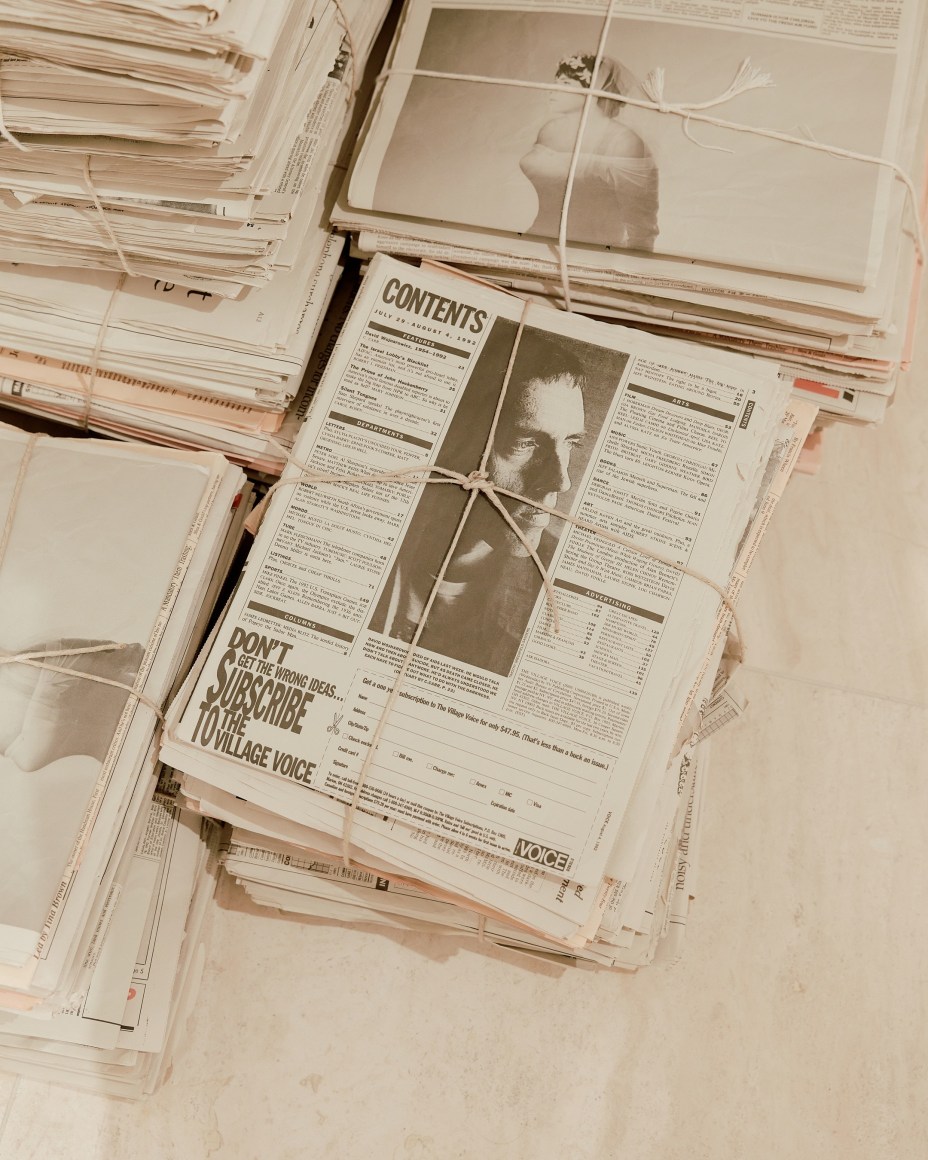 Robert Gober newspapers with various clippings and bundles in stacks.