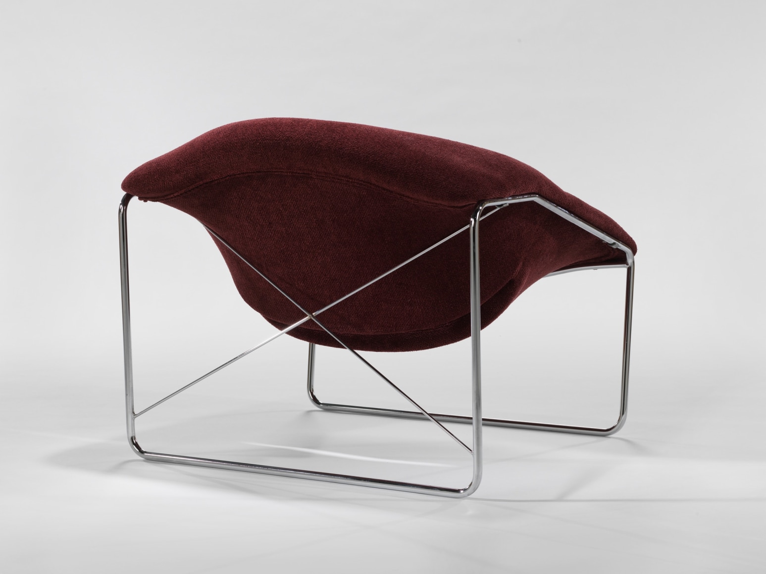 photograph of chair in a blank room with metal legs