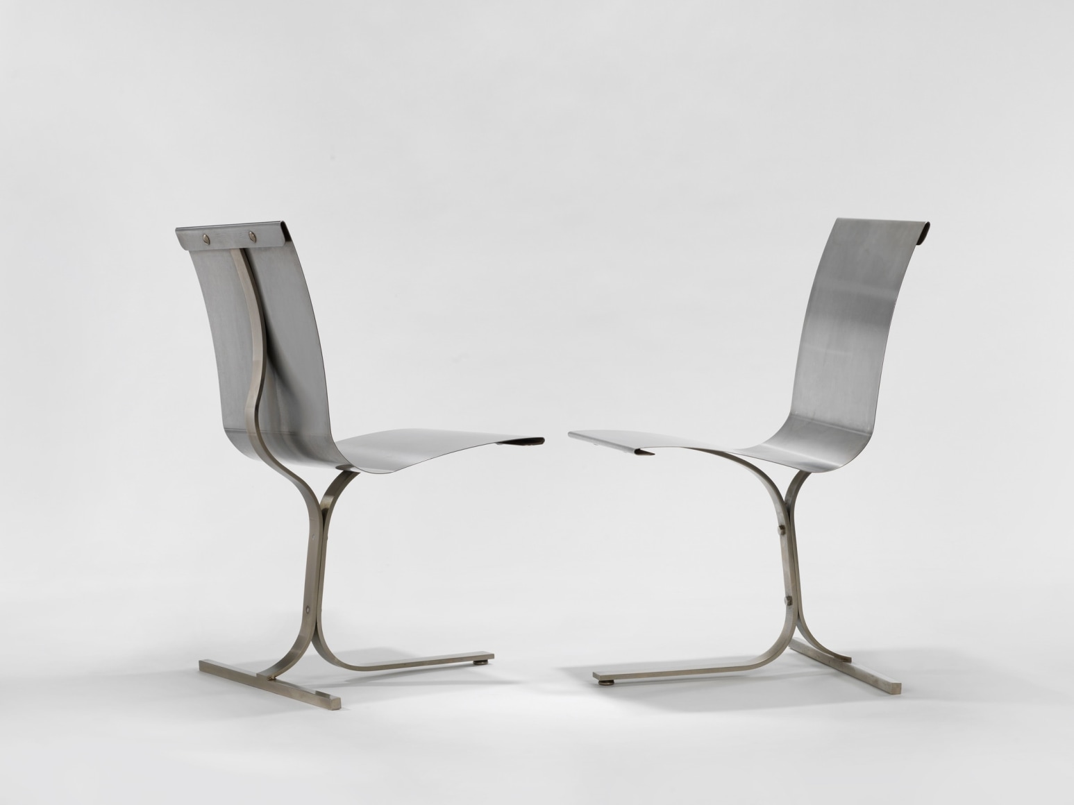 photograph of a blank room with a chair by Charpentier, made of steel