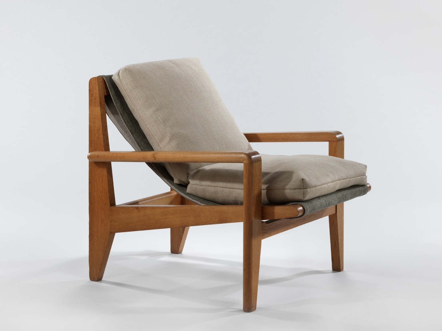 Low wood armchairs with upholstered cushions on seat