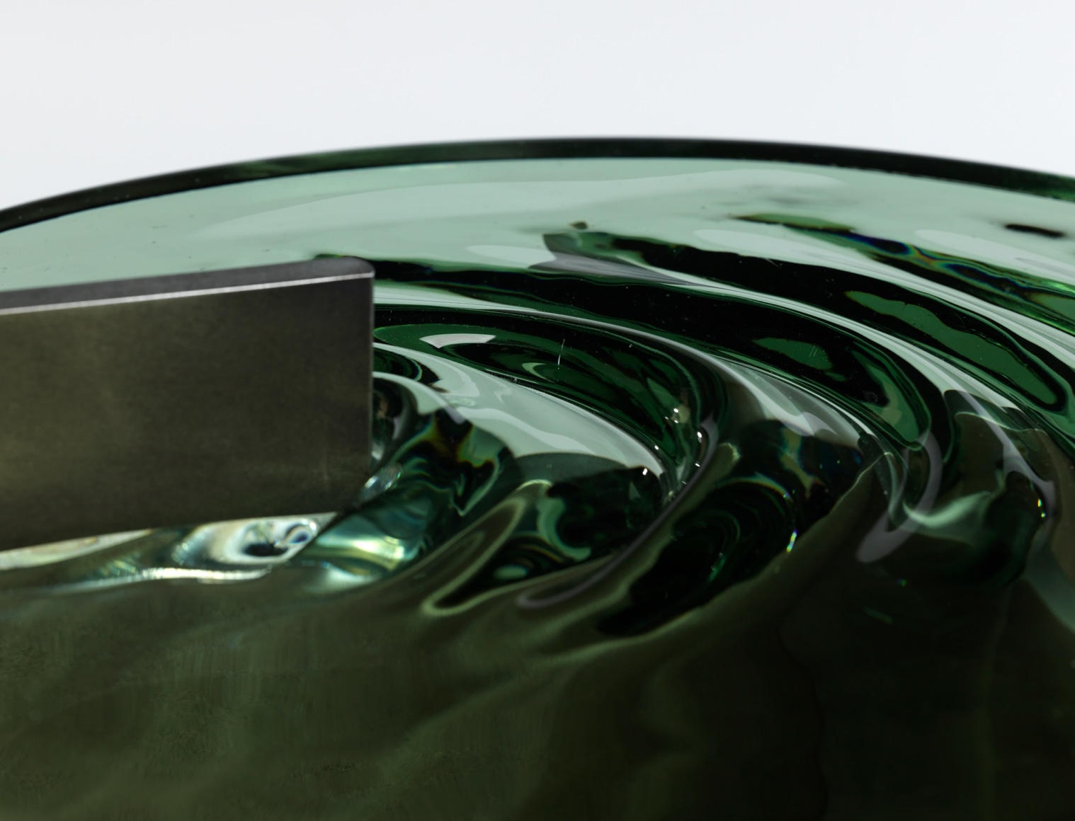 Madonna side table in aluminum and glass against a plain white background.