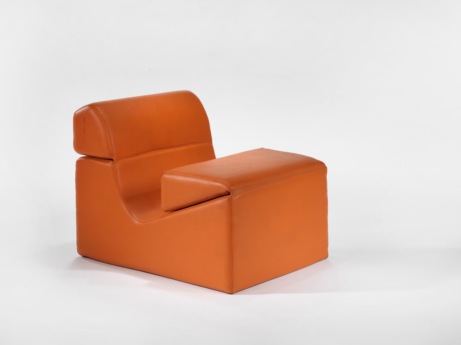 photograph in blank room with chair by Barray, chair is made from foam and vinyl