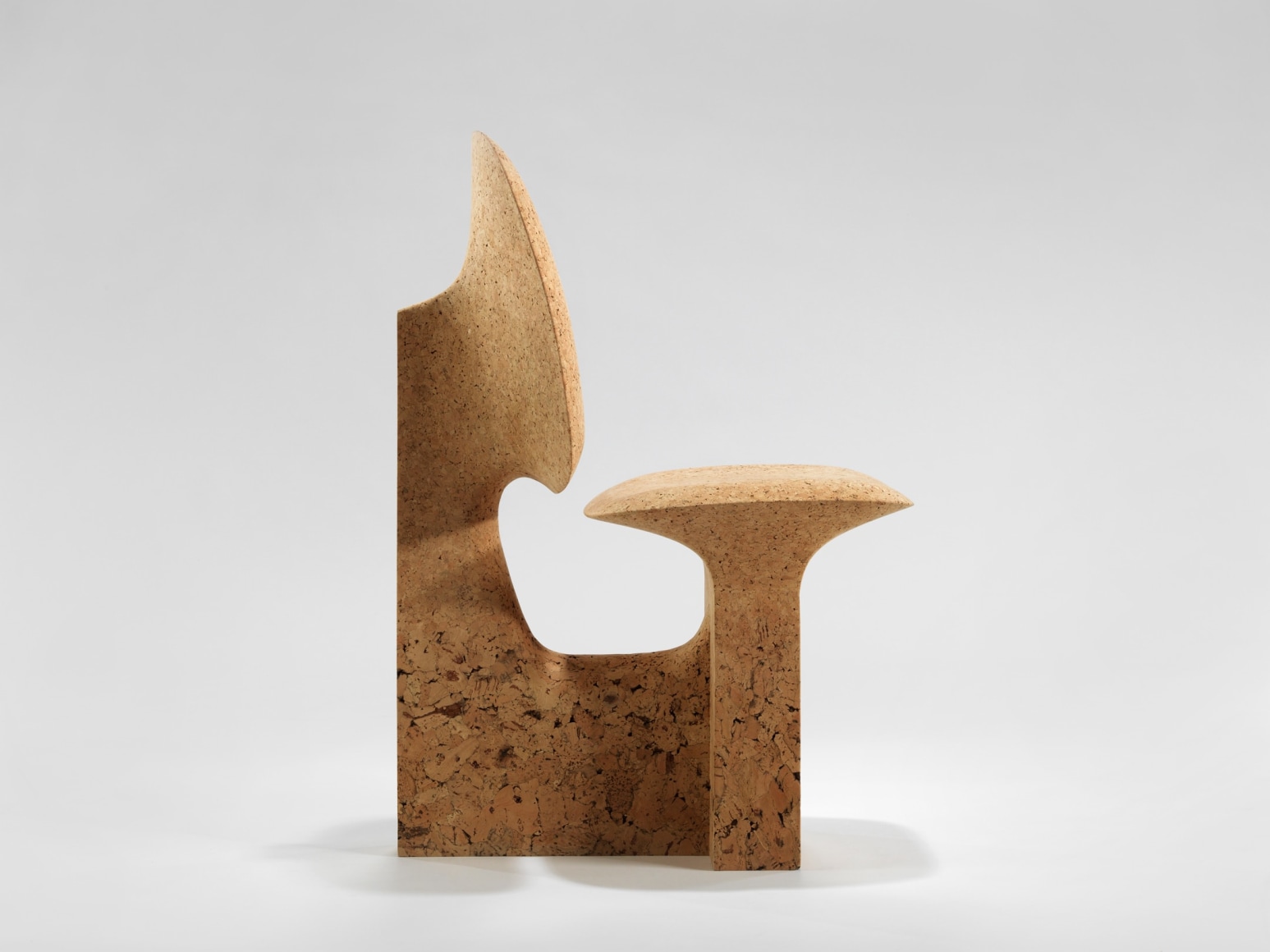cork chair with great curves by made in situ. Image with grey background.
