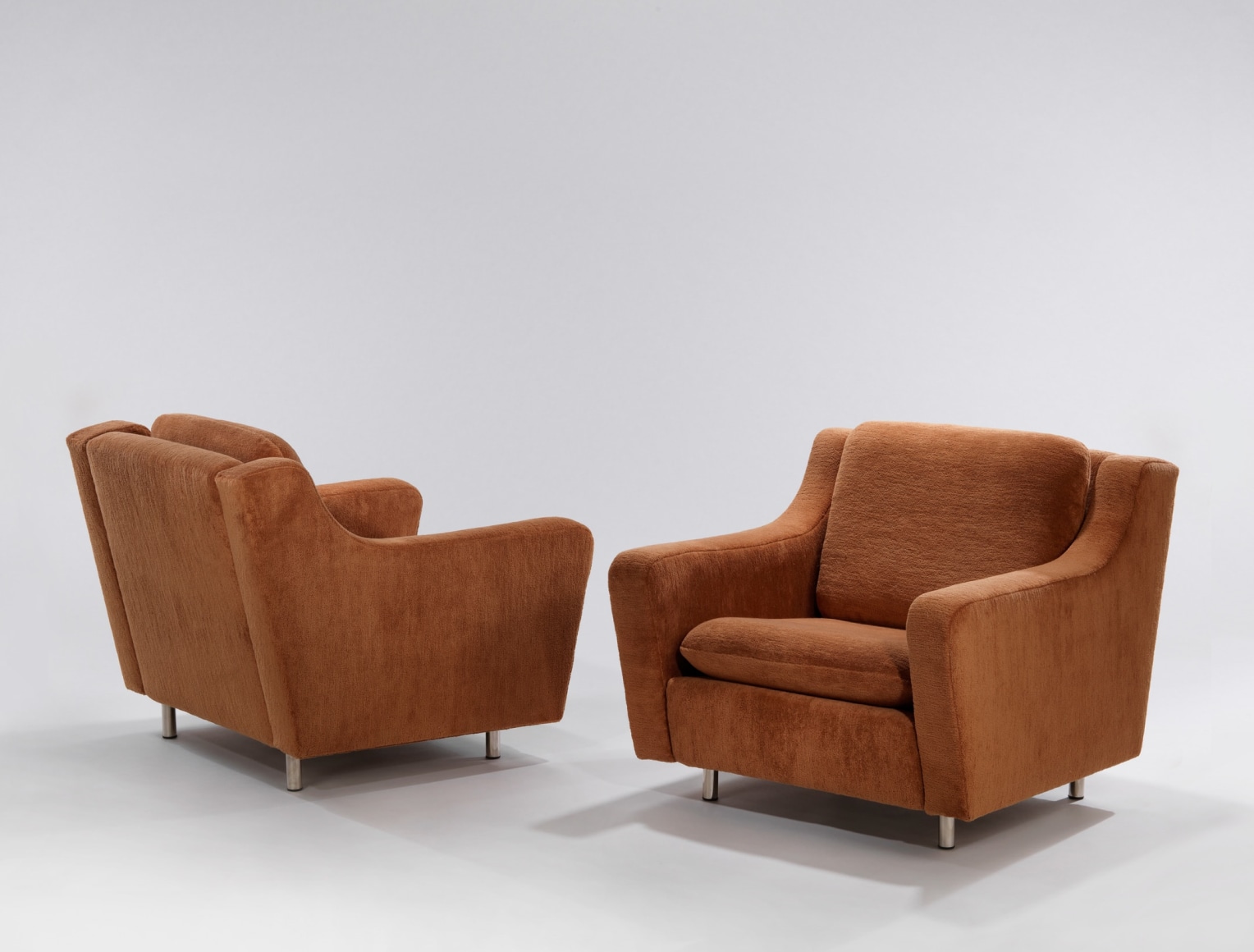 Pair of brown upholstered lounge chair with metal legs