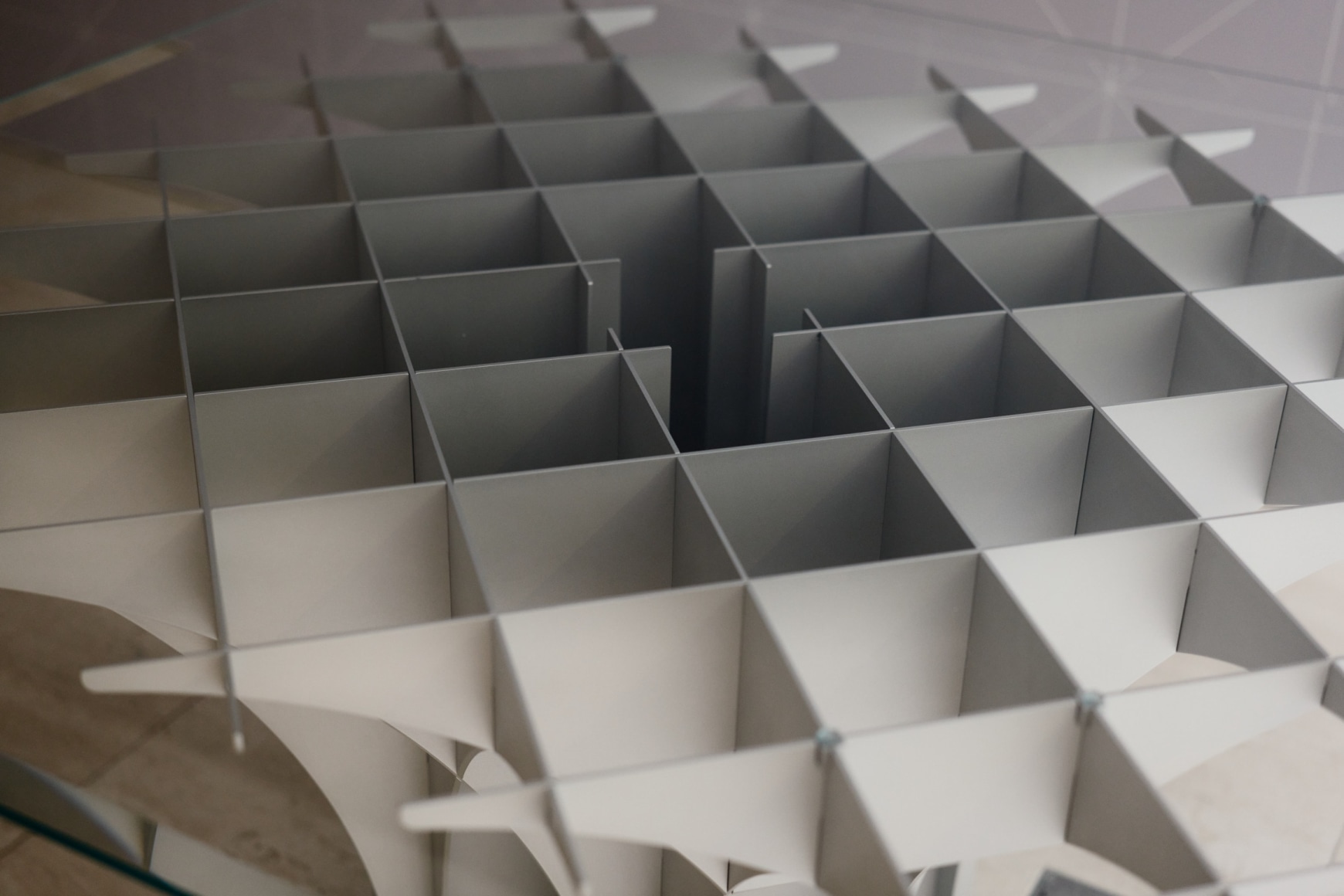 View of Paulin Cathedral Table in the gallery with glass top.