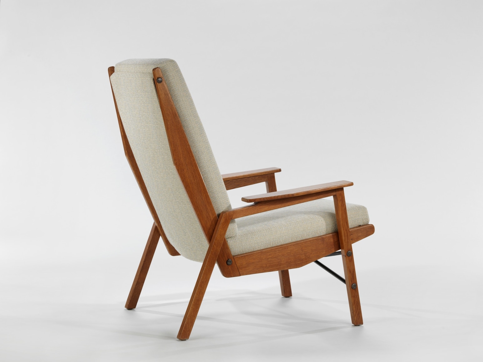 chair with wood legs and arms in a blank room