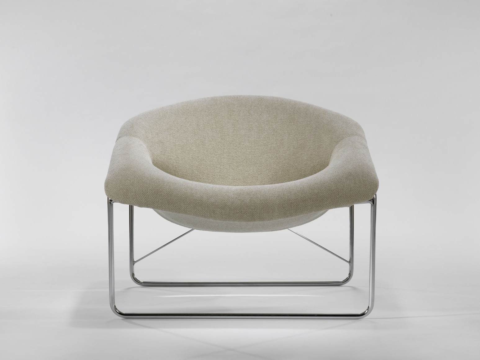 photograph of chair in a blank room with metal legs