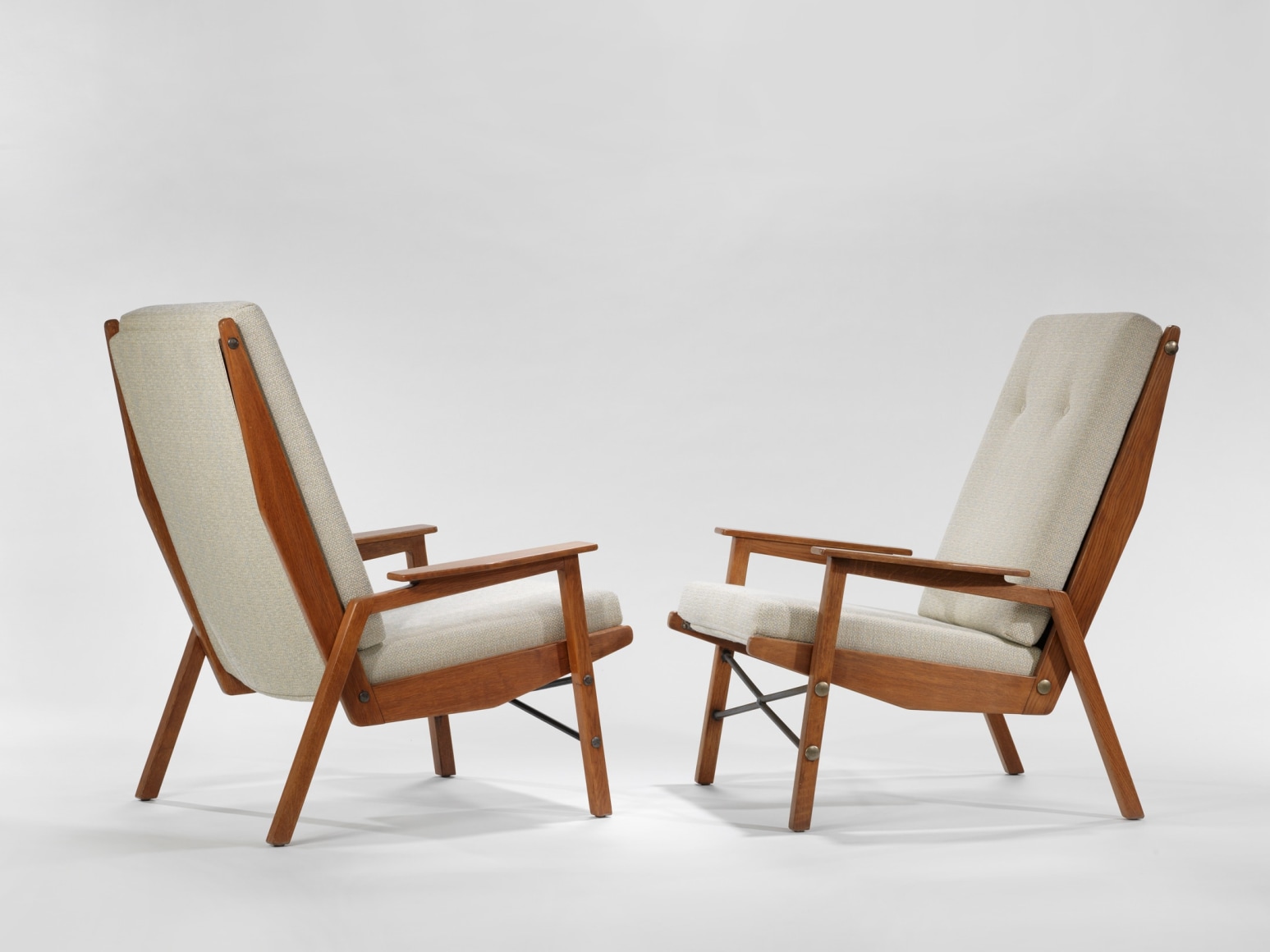 chair with wood legs and arms in a blank room