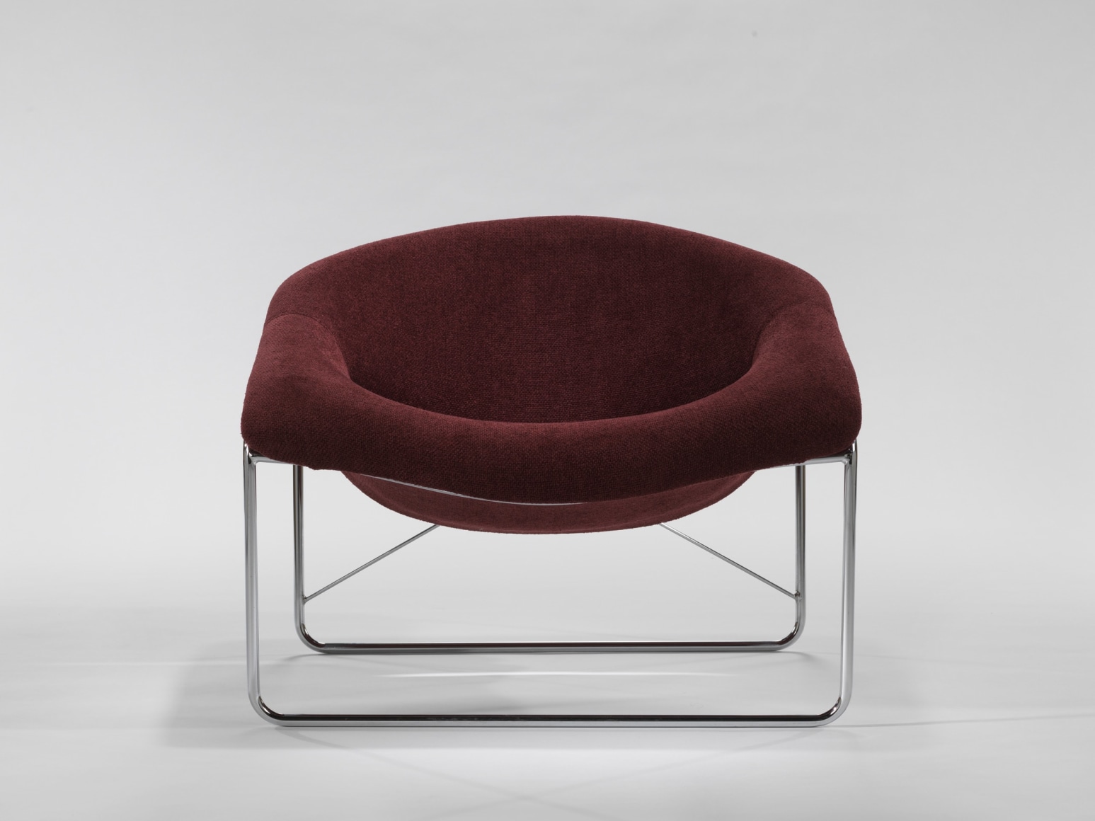 photograph of chair in a blank room with metal legs