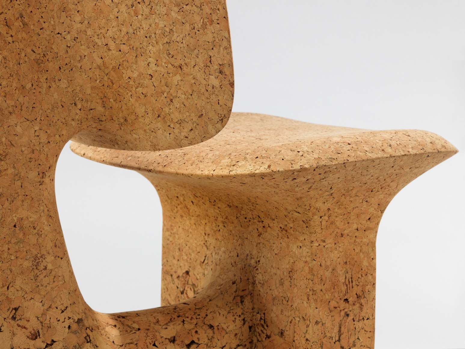 cork chair with great curves by made in situ. Image with grey background.