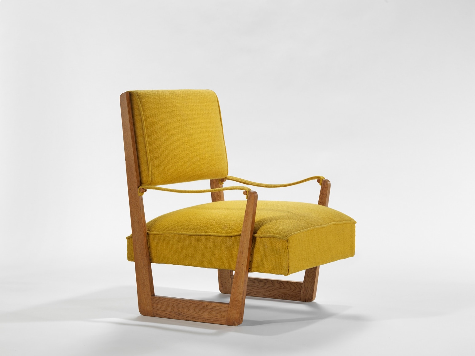 yellow and wood armchairs in an empty room