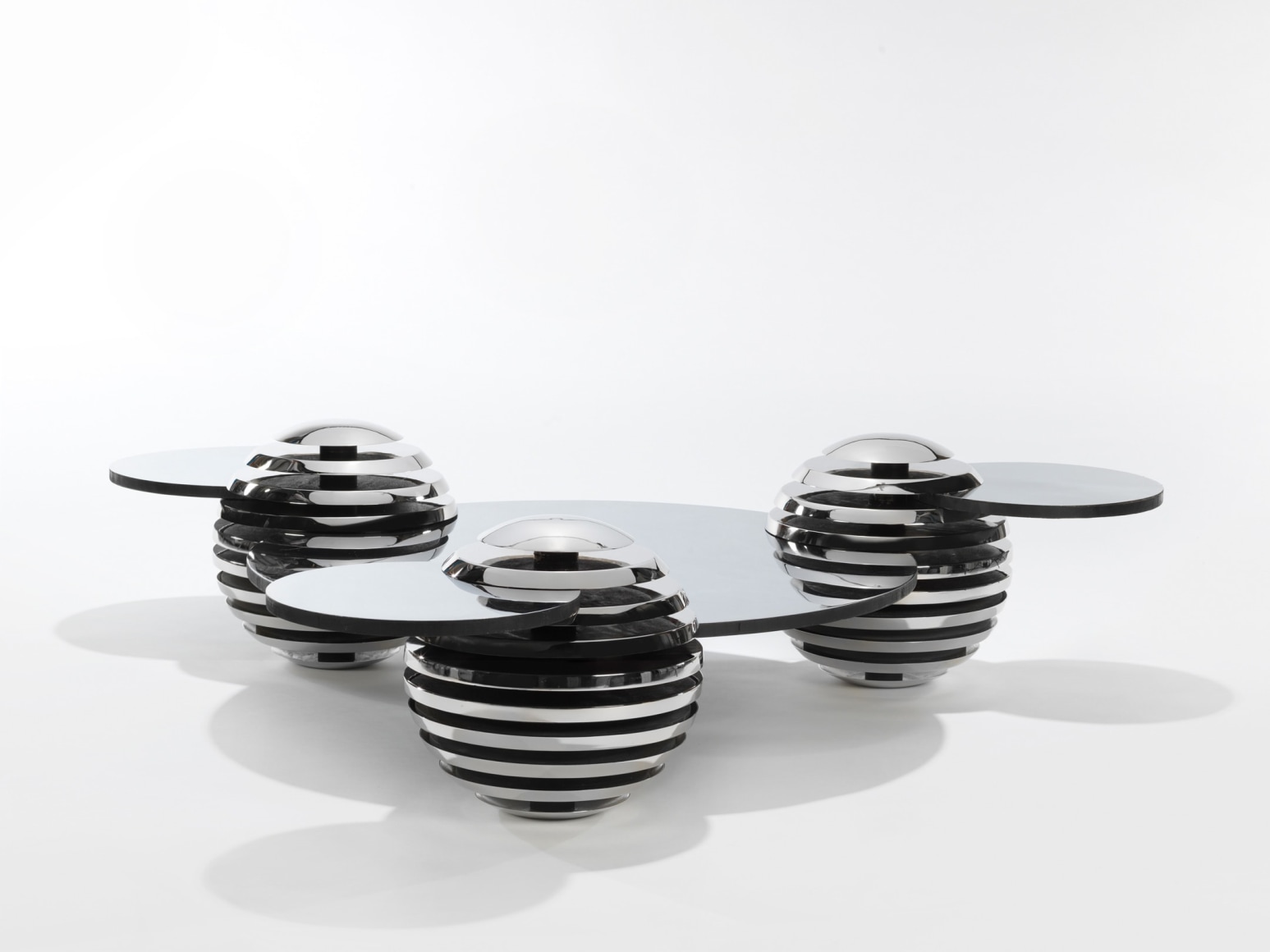 Steel and metal table by Mansau in a blank room