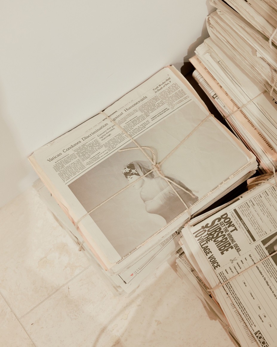 Robert Gober newspapers with various clippings and bundles in stacks.