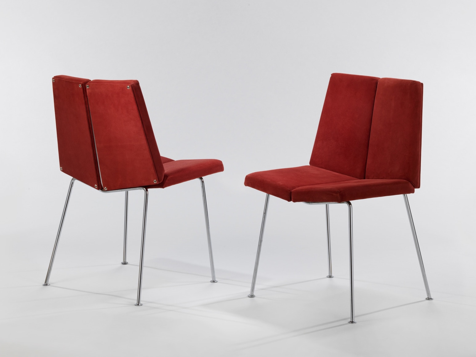 Both chairs made by Pierre guariche in image.