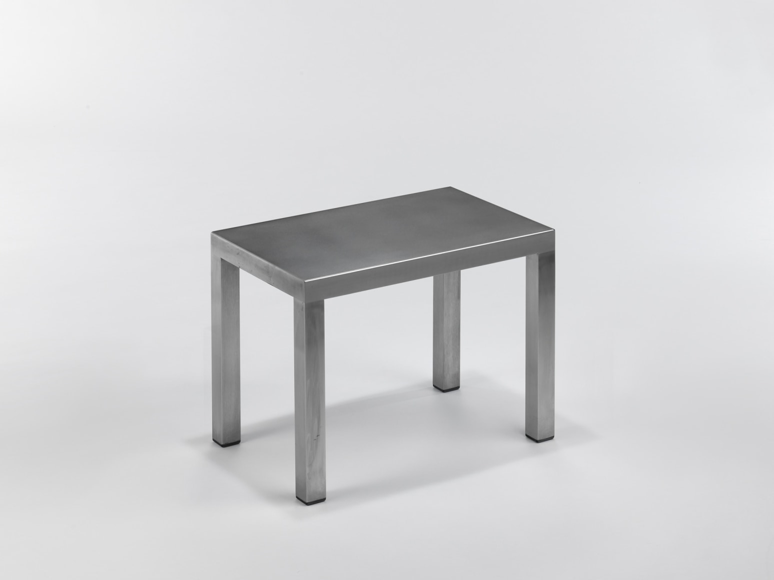 Stainless steel end tables in frond of white background