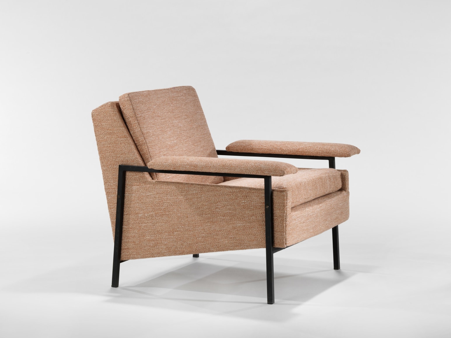 two pink armchairs in an empty room