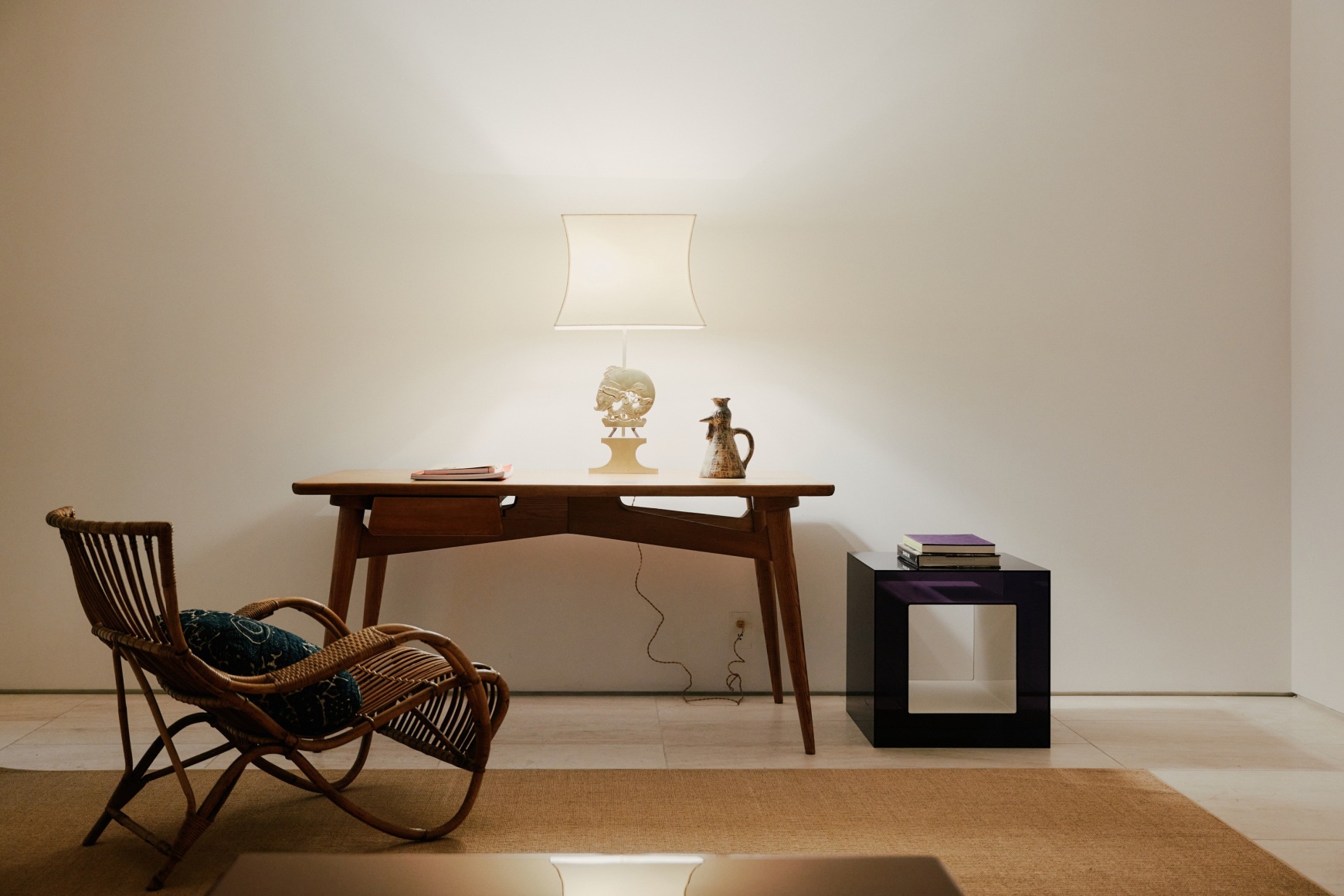 Installation view of works in the gallery, mostly furniture and some rugs and art.