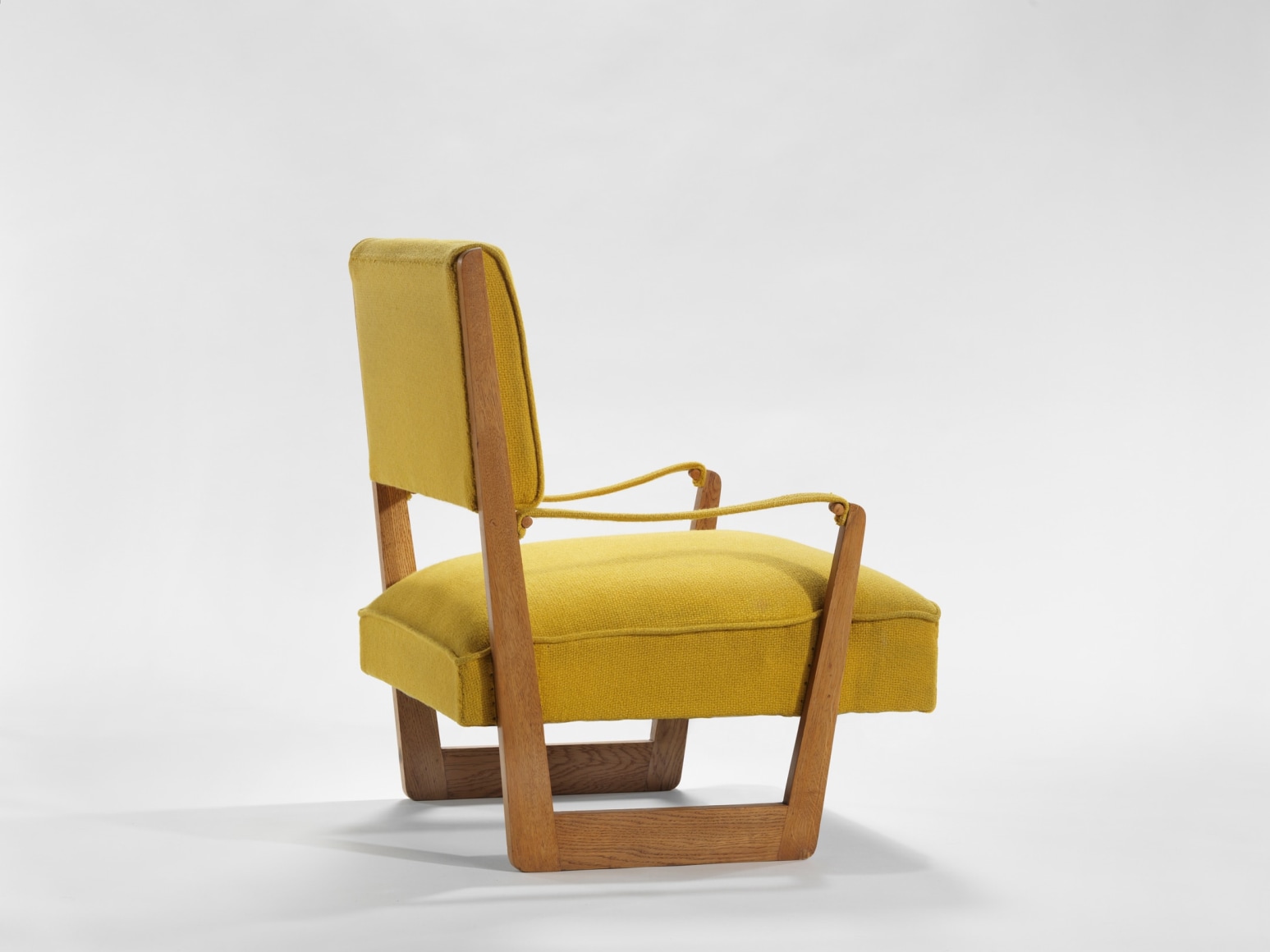 yellow and wood armchairs in an empty room
