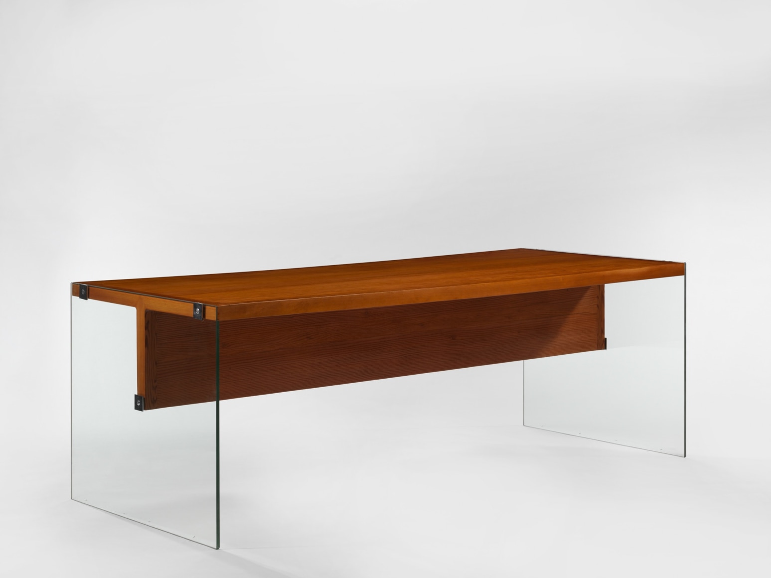 photograph of wooden desk by Motte in a blank room