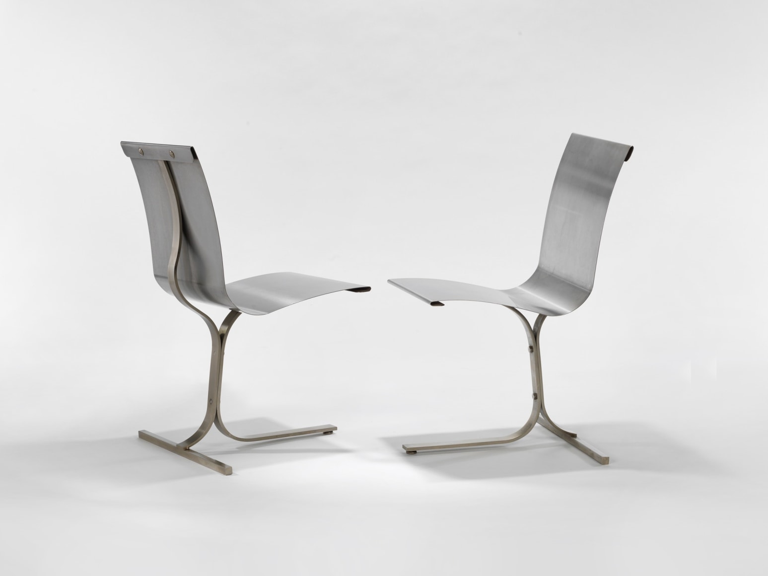photograph of a blank room with a chair by Charpentier, made of steel