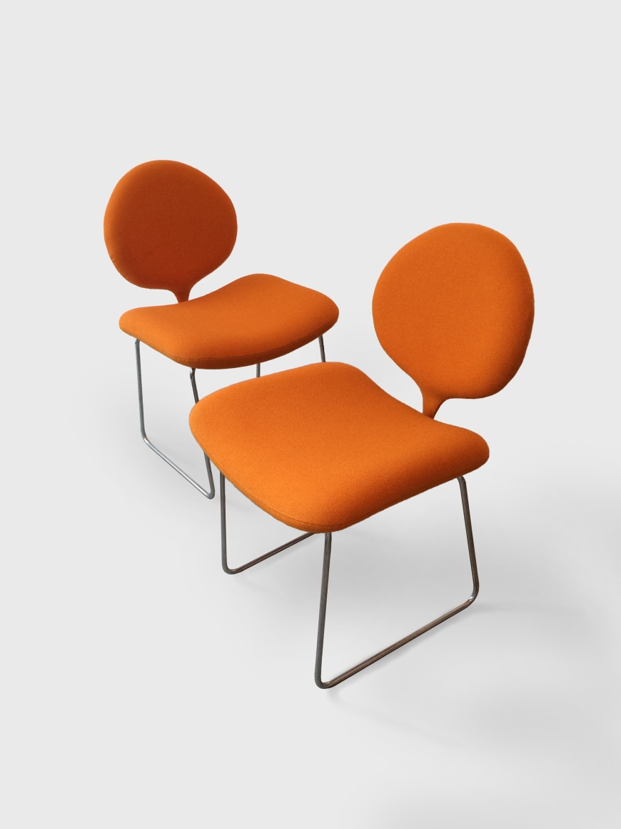 orange chairs in a white room