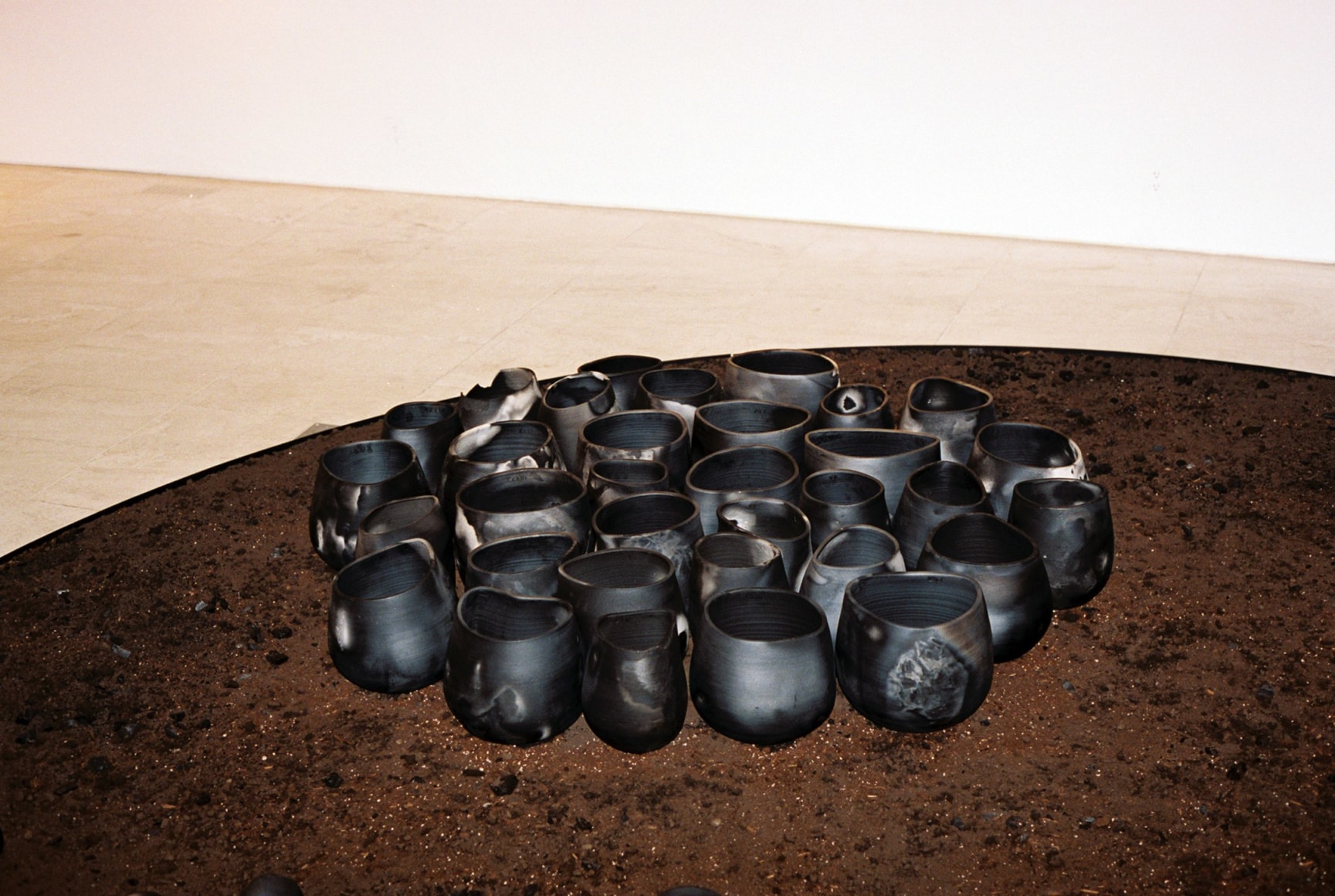 Barro Negro vases soil pit installation on view in Demisch Danant gallery NYC