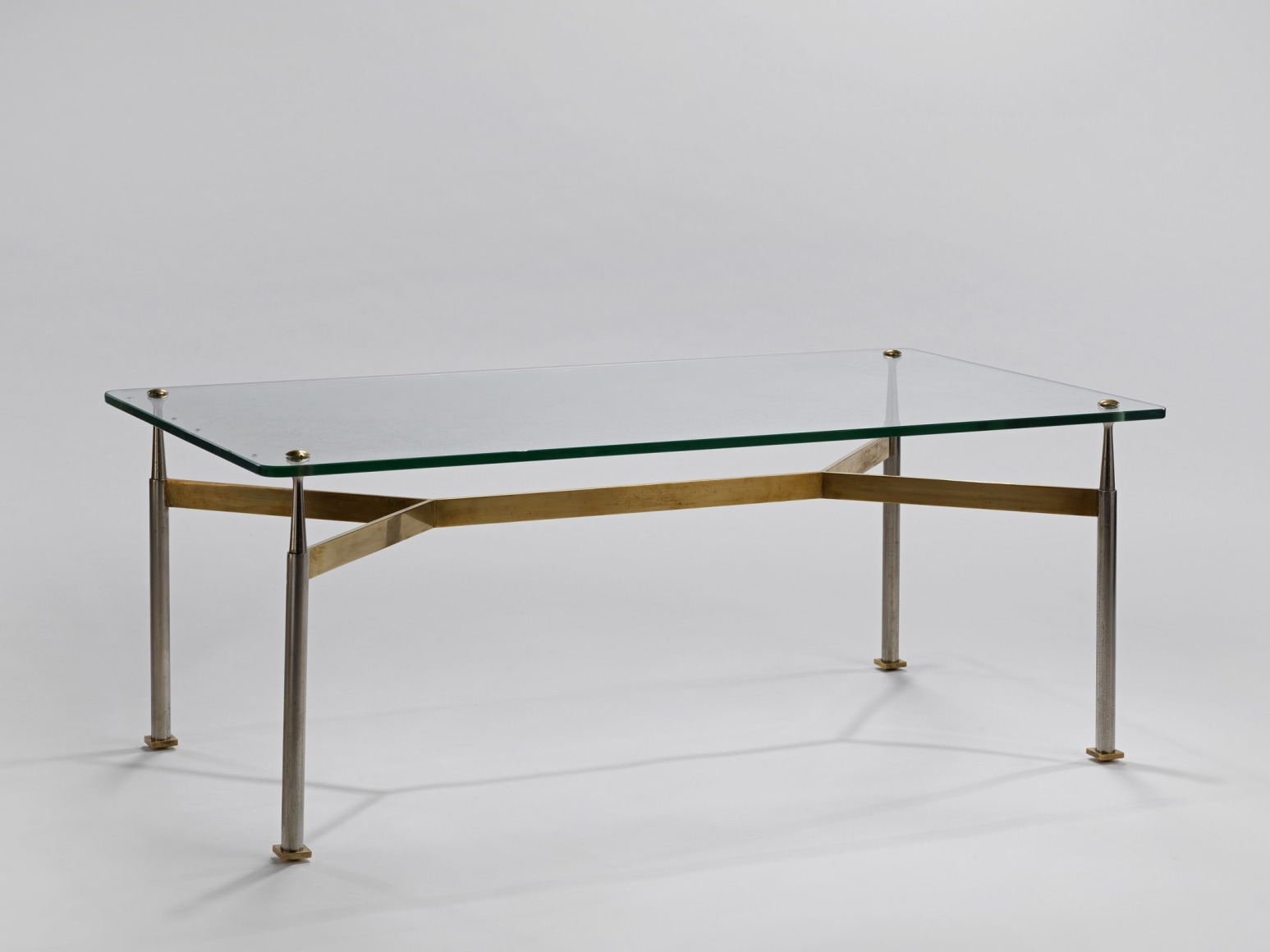 Glass top coffee table with a brass base