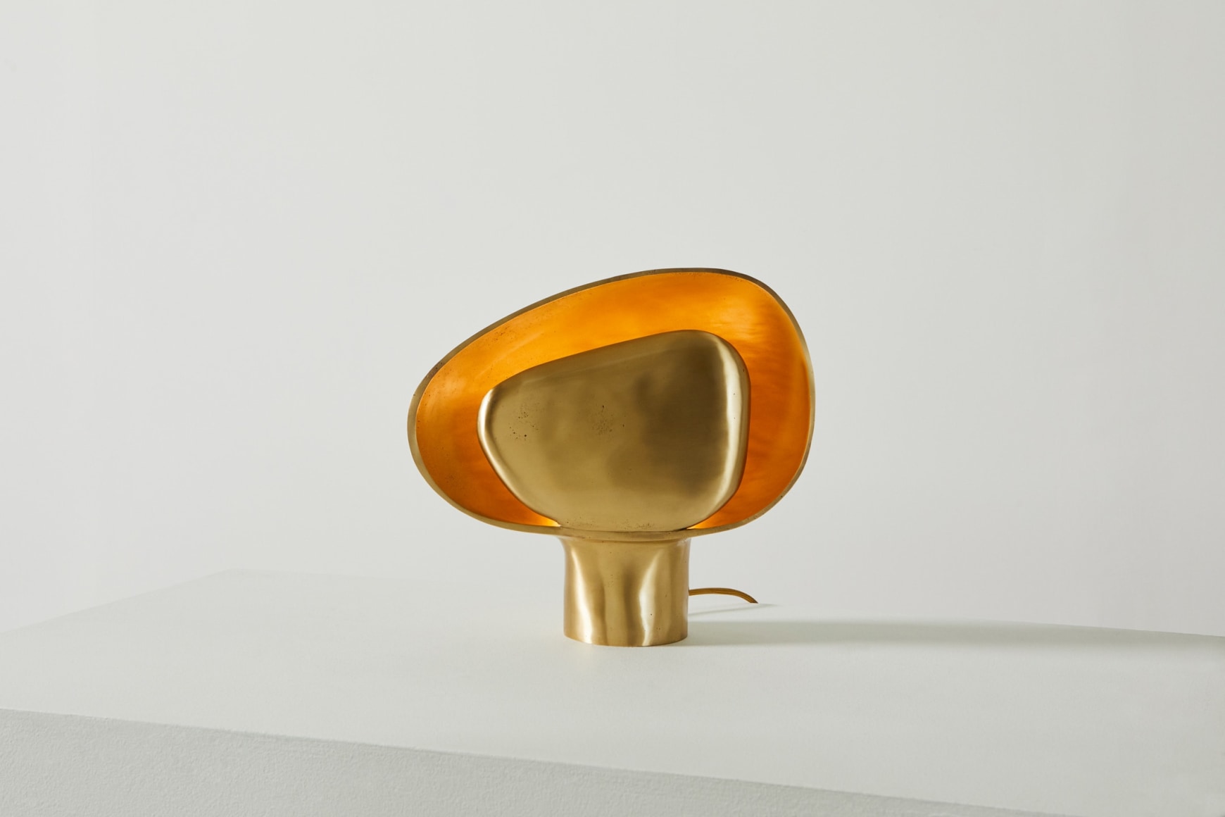 Organically shaped bronze table lamp in on position
