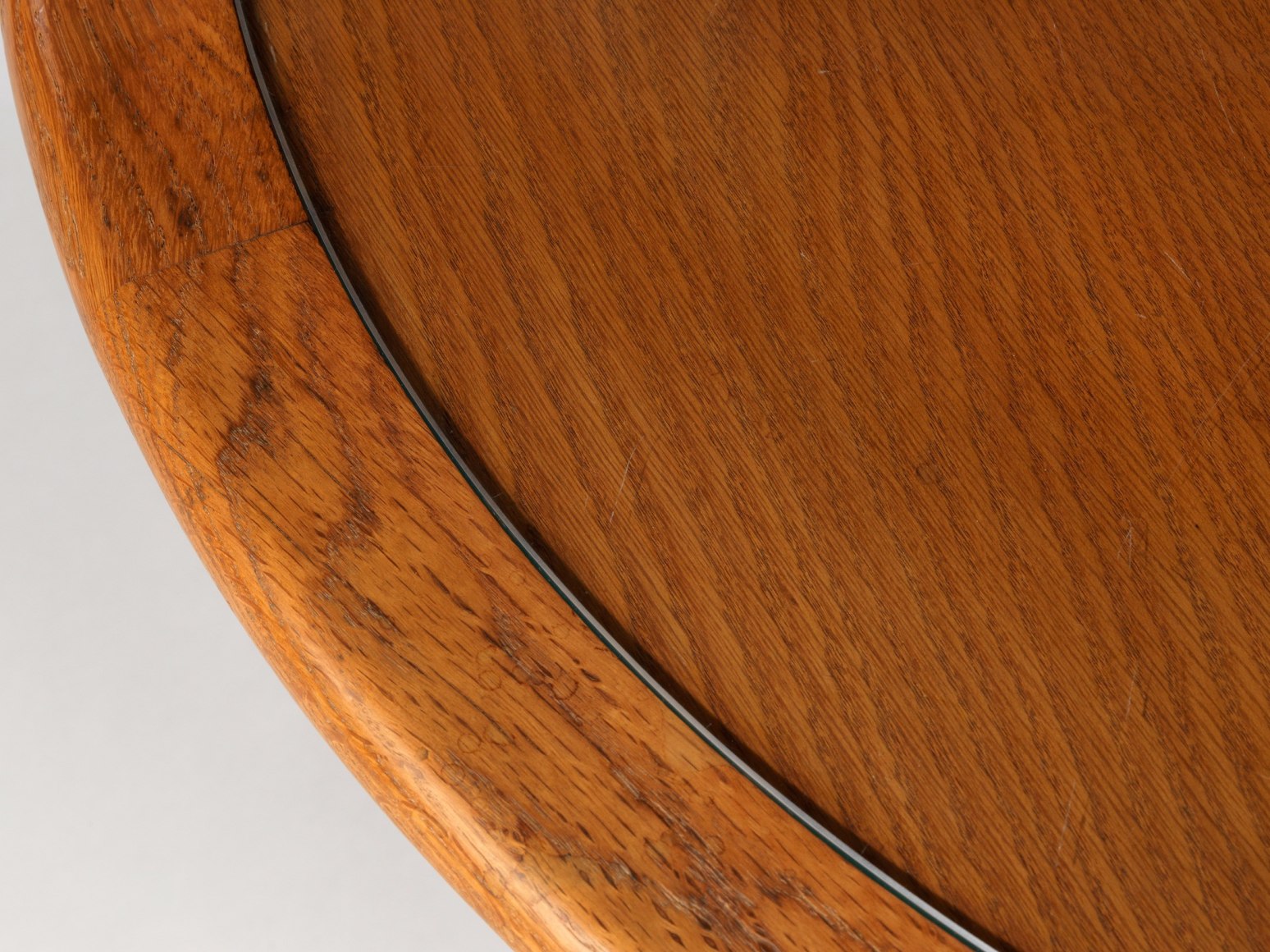 Wooden table with cross base and glass top by Renou and Genniset. View from close up.