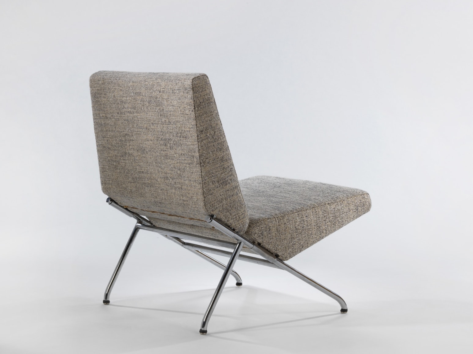 Back view of steel based upholstered lounge chair