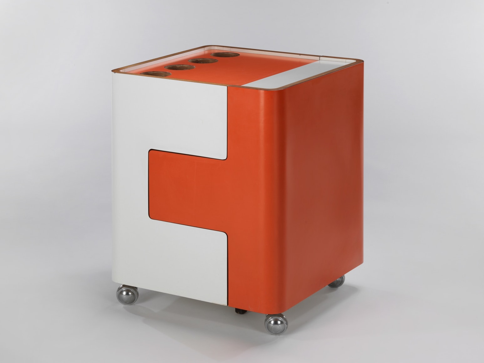 Bar cart in orange and white shown open and closed with different holes for various parts.