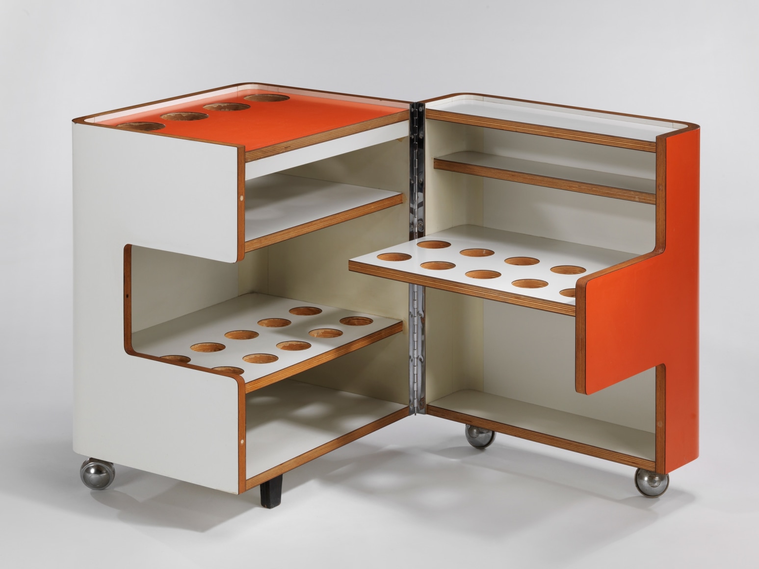 Bar cart in orange and white shown open and closed with different holes for various parts.