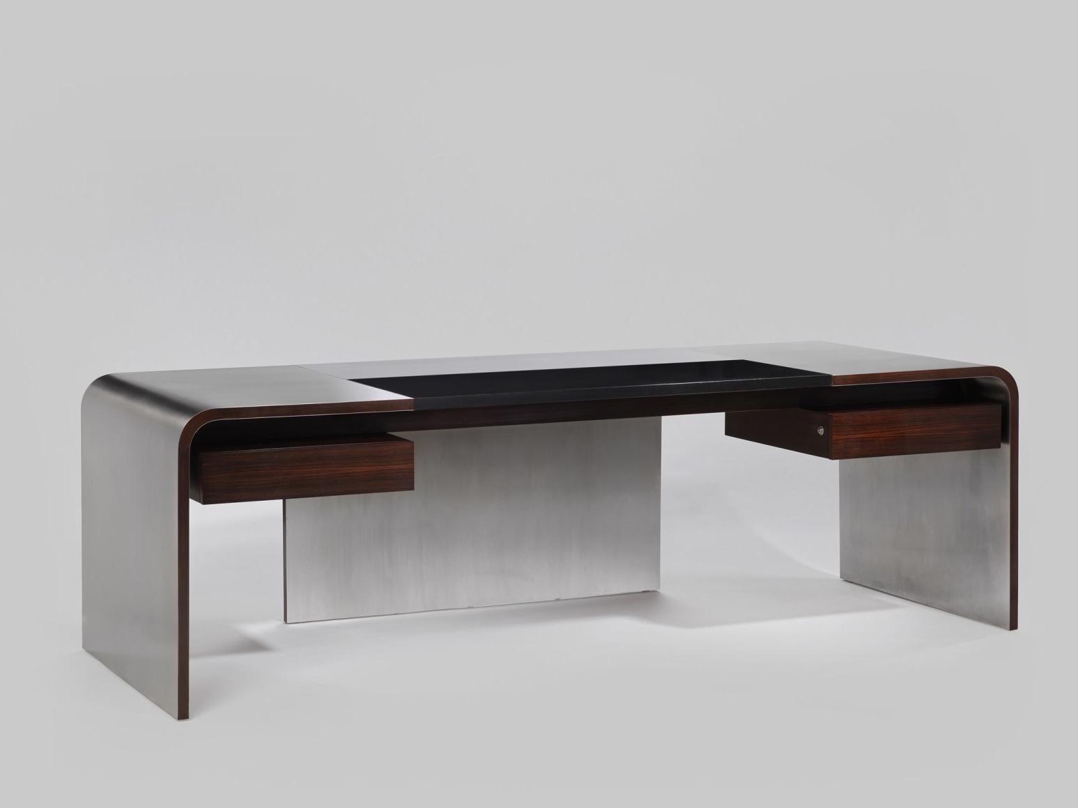View of stainless steel desk with wooden drawers from seated perspective