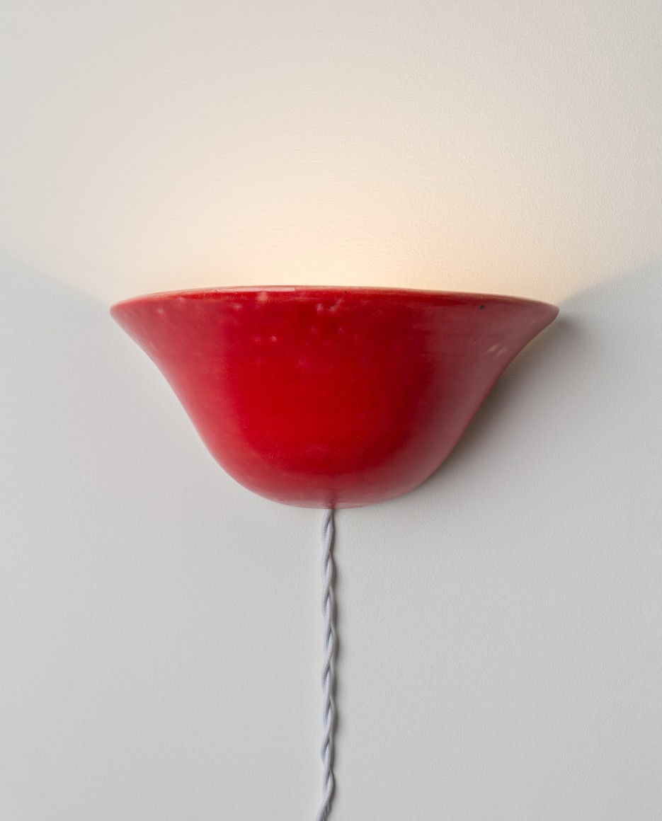 red sconce on a gray wall