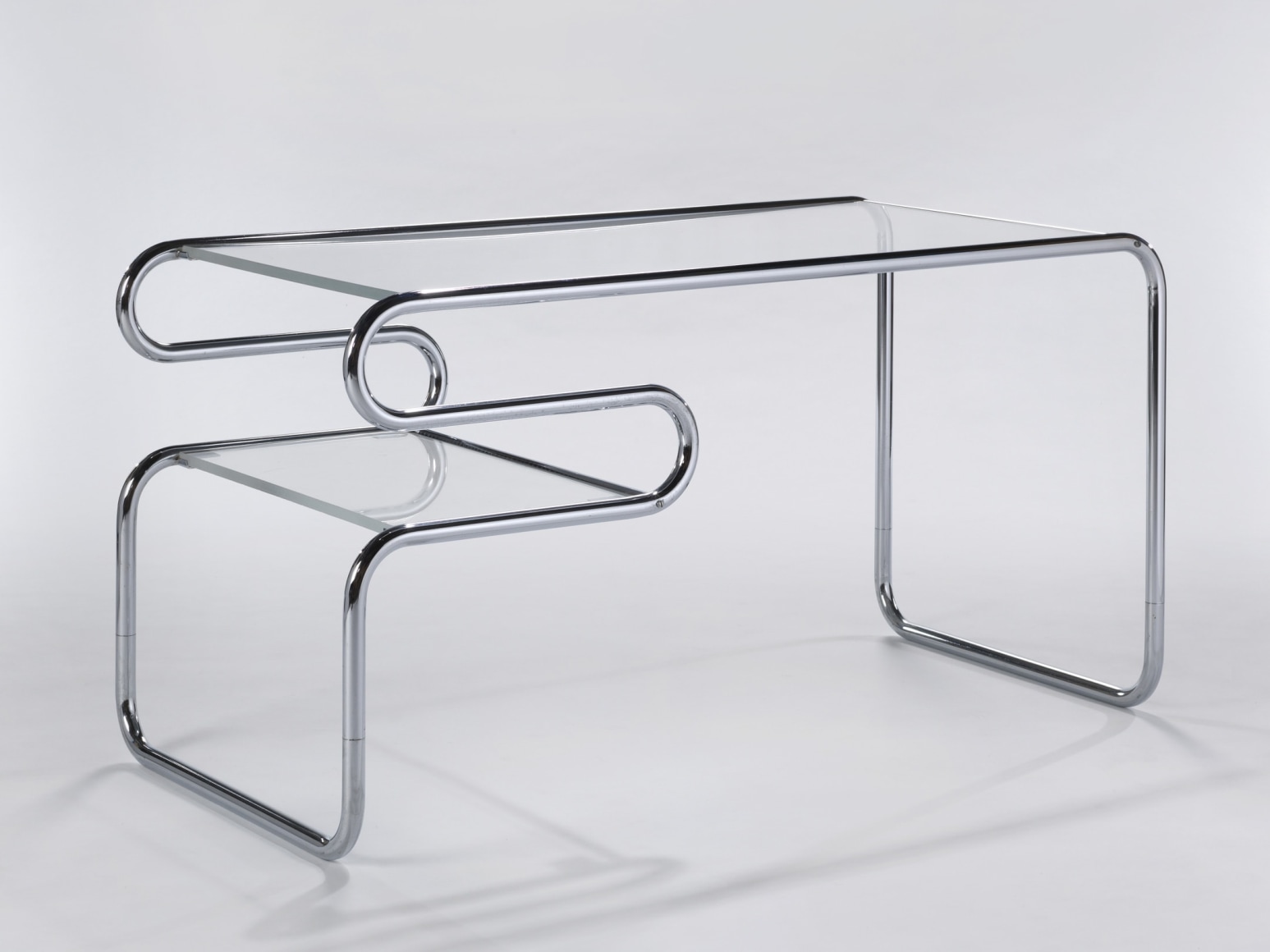 Back of chrome tubular glass topped desk by Michel Hamon