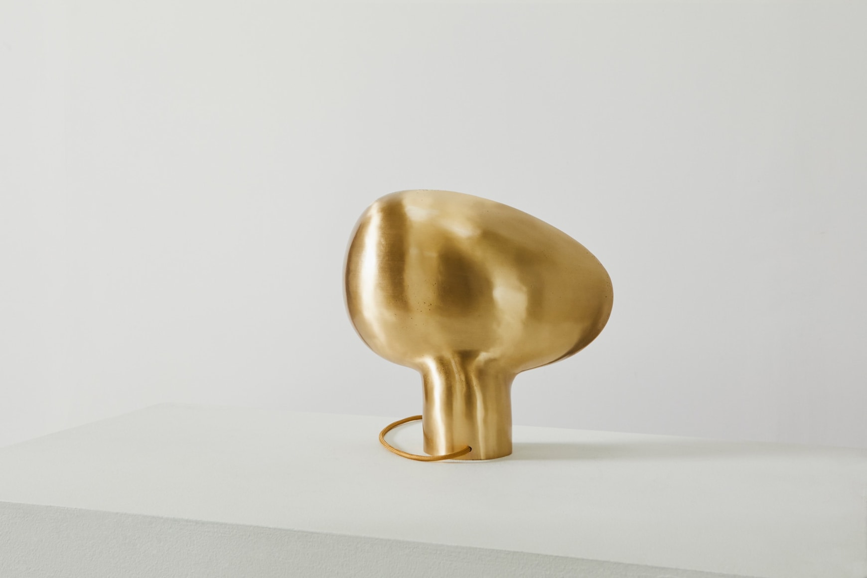 Back view of organically shaped bronze table lamp in on position