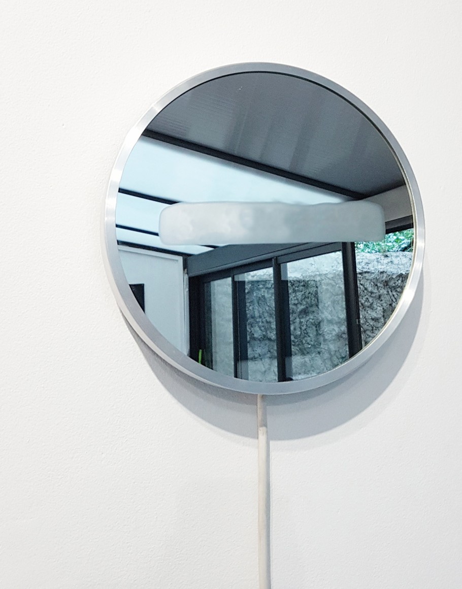 photograph of a mirror on a white wall