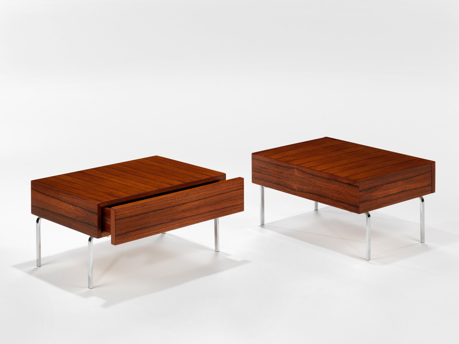 photograph of 2 side tables by Fermigier, tables have metal legs and teak tops