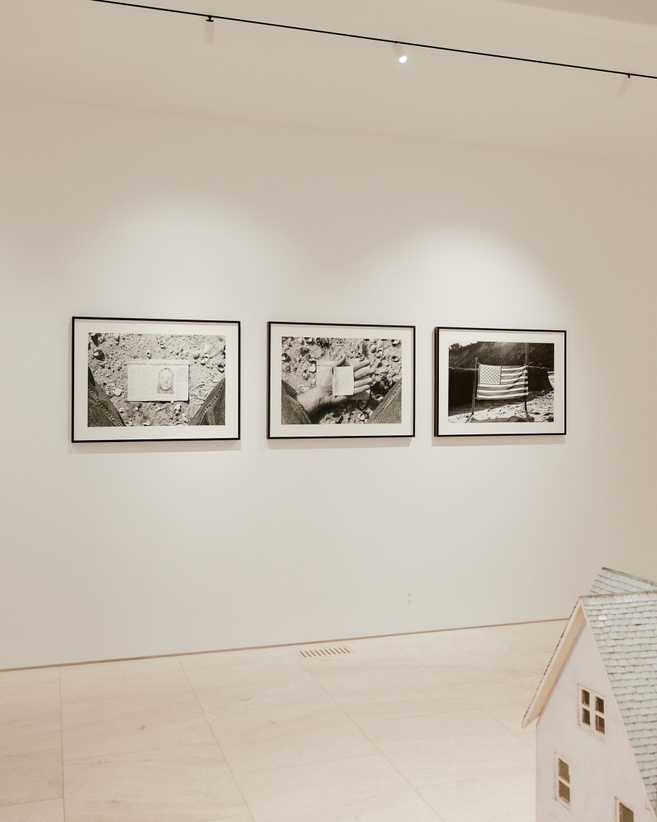 black and white photograph of newspaper clipping in a hand